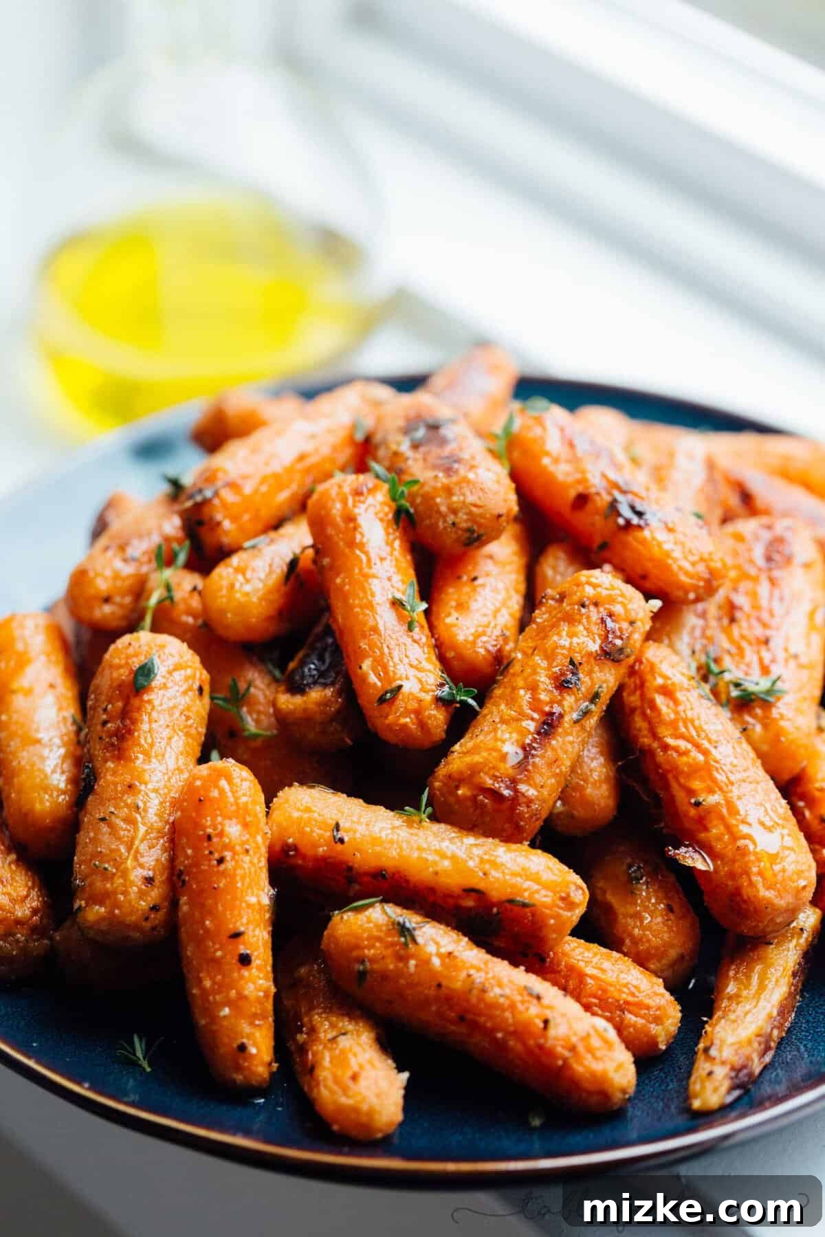 Parmesan Crusted Roasted Carrots 5 A serving of roasted parmesan carrots in a rustic bowl, showcasing their golden-brown edges and tender texture.