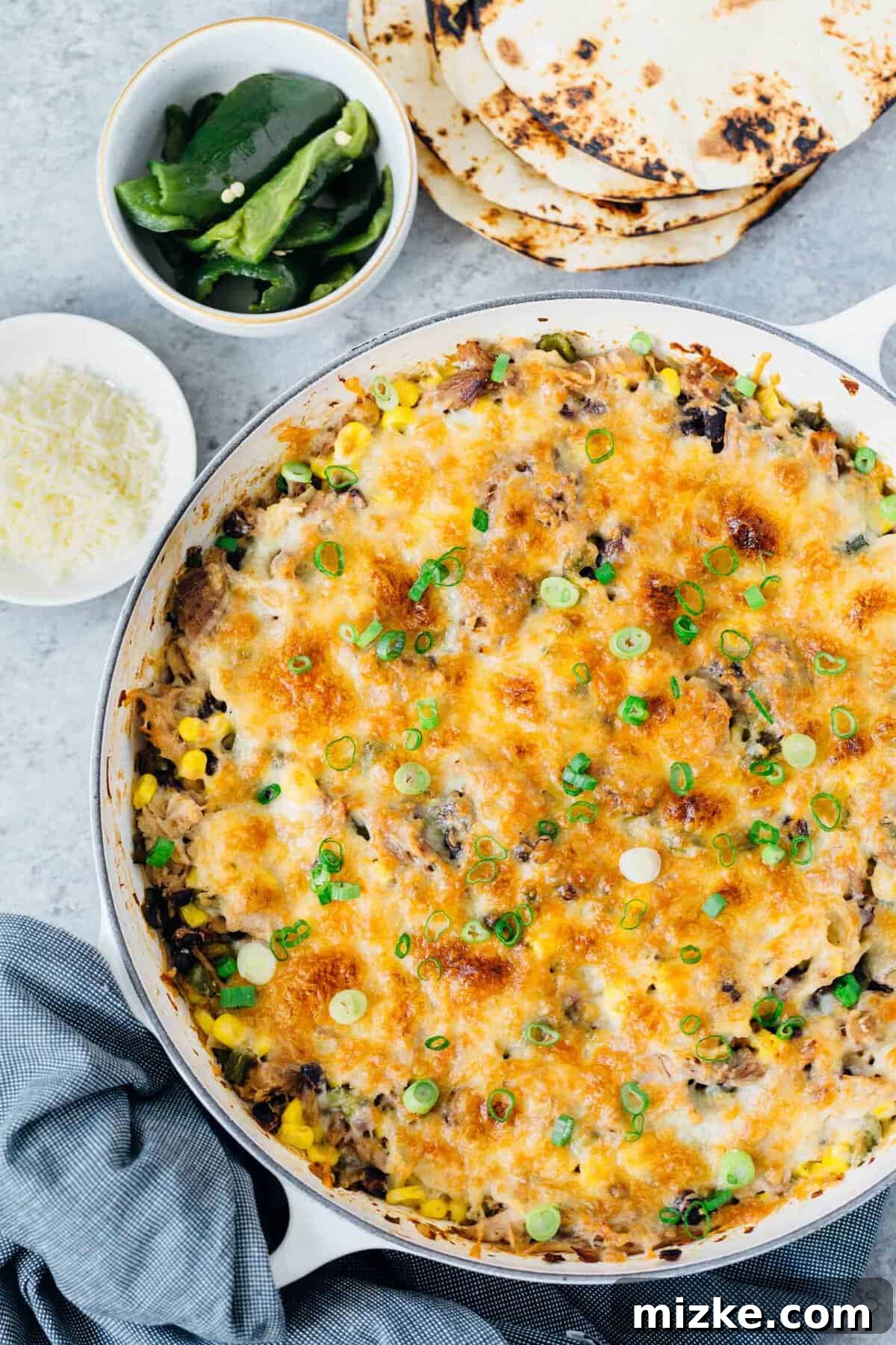 Instant Pot pork poblano skillet enchiladas are full of flavor and put together fairly easily for a crowd pleasing meal! #instantpot #pressurecooker #instantpotrecipe #instantpotpork #porkrecipe #porkpoblano #skilletenchiladas