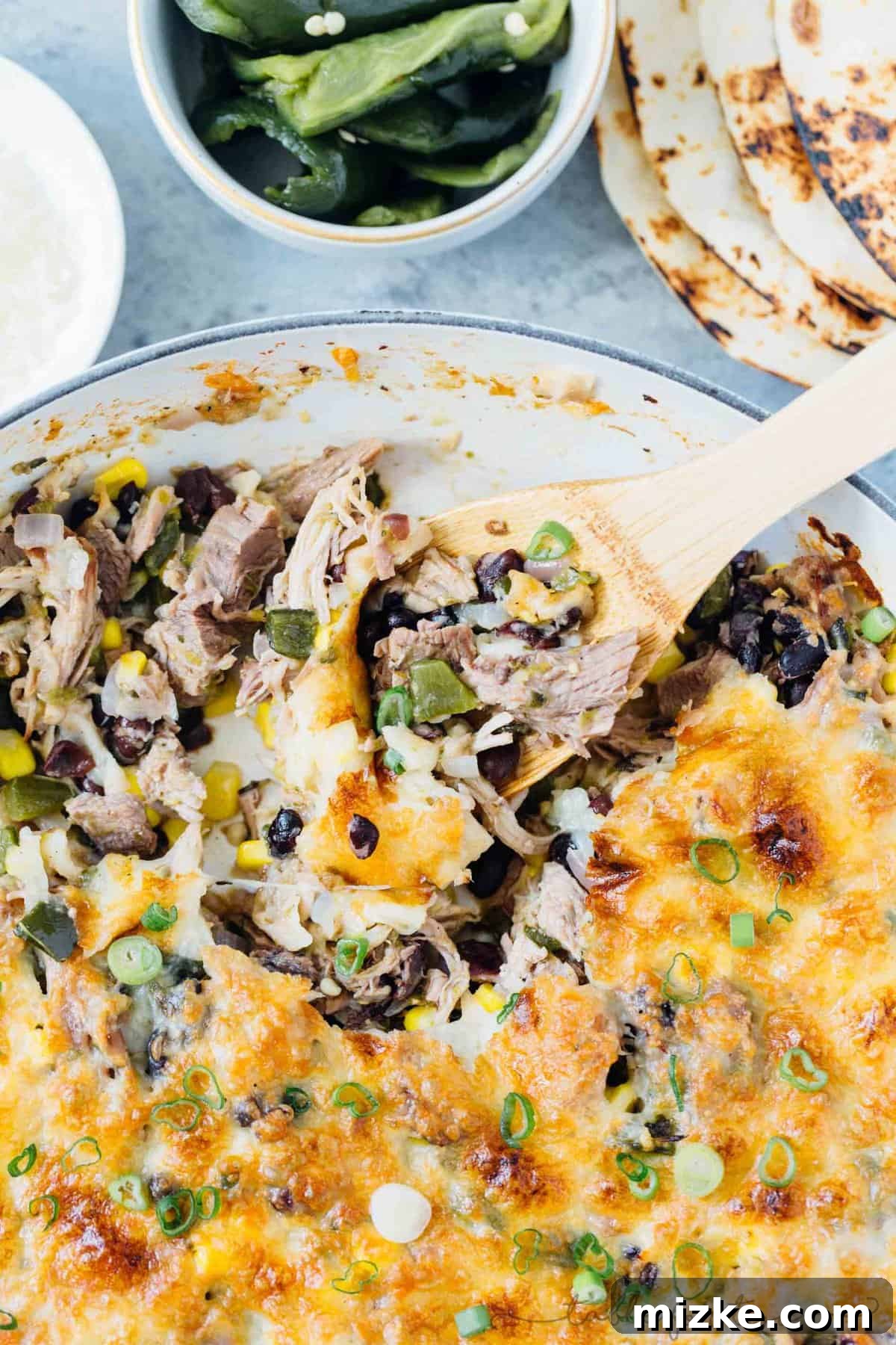 Instant Pot pork poblano skillet enchiladas are full of flavor and put together fairly easily for a crowd pleasing meal! #instantpot #pressurecooker #instantpotrecipe #instantpotpork #porkrecipe #porkpoblano #skilletenchiladas