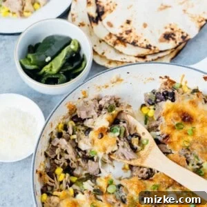 Instant Pot pork poblano skillet enchiladas are full of flavor and put together fairly easily for a crowd pleasing meal! #instantpot #pressurecooker #instantpotrecipe #instantpotpork #porkrecipe #porkpoblano #skilletenchiladas