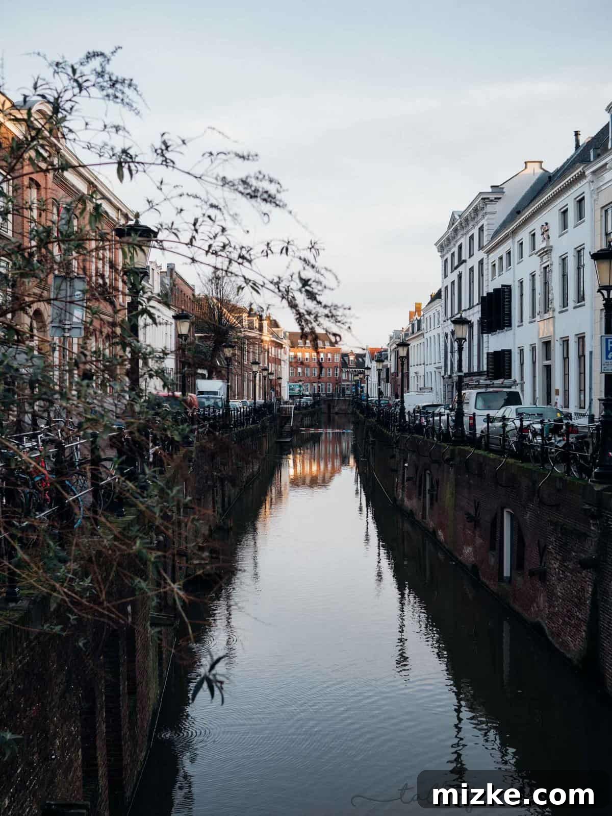 Utrecht: Discovering the Netherlands' Vibrant Heart 2 Panoramic view of Utrecht's scenic Oudegracht canal, lined with historic wharf cellars and charming houses – perfect for a day trip from Amsterdam.