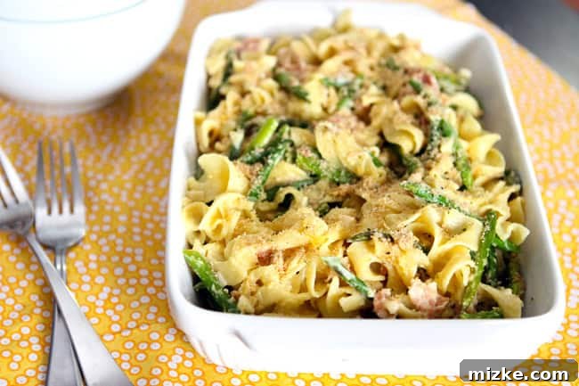 Spring Carbonara with Asparagus, Crispy Pancetta, and Lemon Herb Crumble 3 Close-up of finely diced pancetta sizzling in a hot skillet, rendering its fat to create a flavorful base for the carbonara sauce.