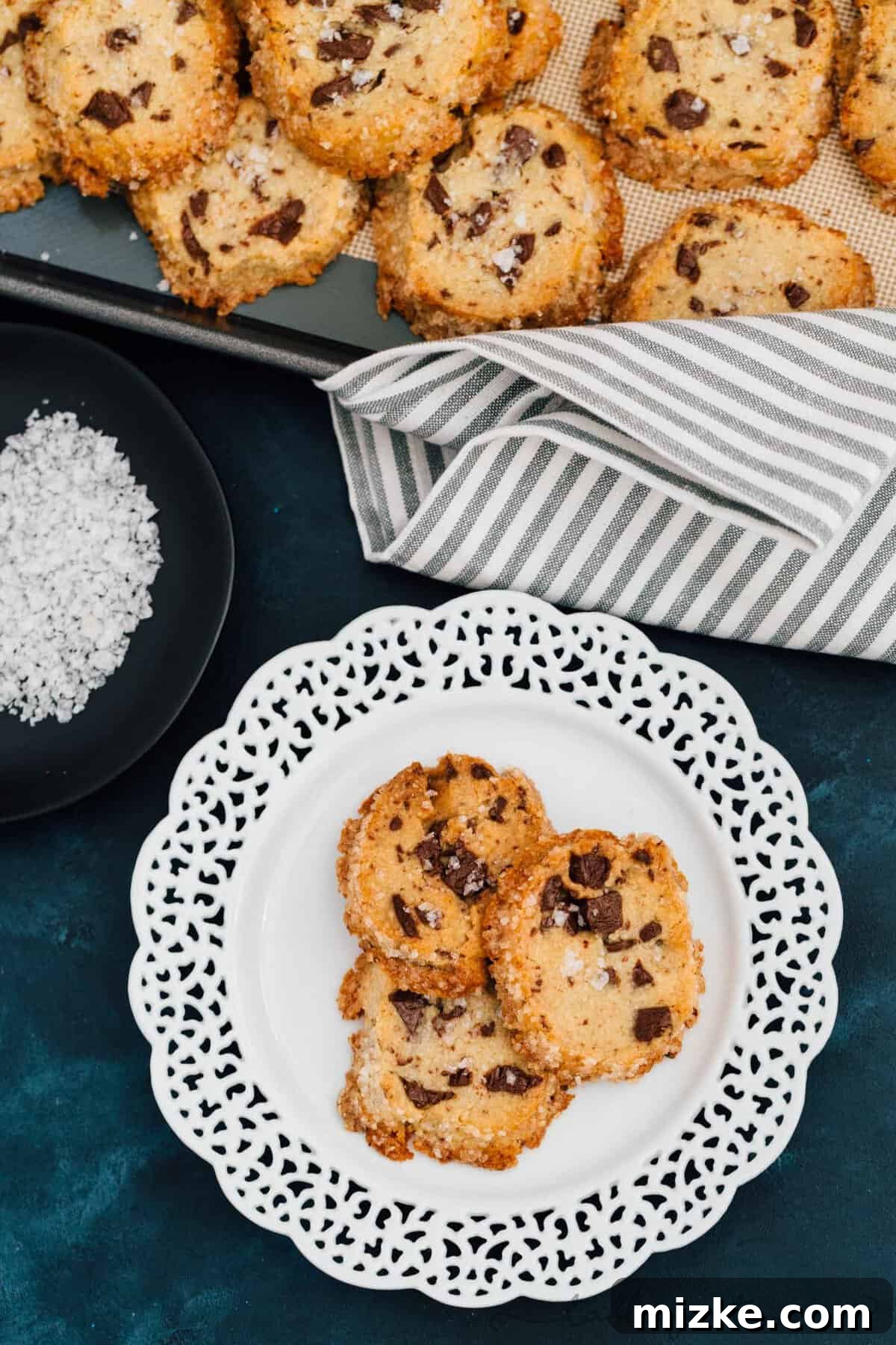 Freshly baked salted shortbread chocolate chunk cookies cooling on a rack, showcasing their golden edges and melty chocolate. An irresistible classic reinvented by Alison Roman.