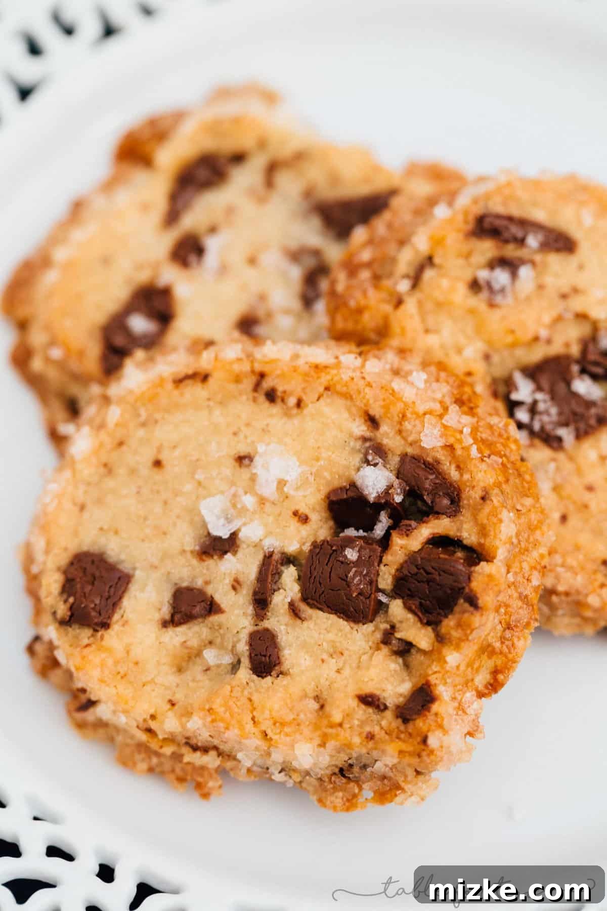 Unbaked logs of salted shortbread chocolate chunk cookie dough, ready for chilling and slicing. A testament to the thick, firm consistency essential for this unique shortbread recipe.