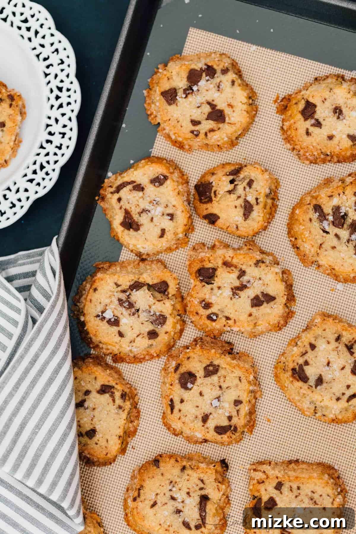 Stacked salted shortbread chocolate chunk cookies, showcasing their inviting texture and rich chocolate, ready to be enjoyed with a glass of milk.