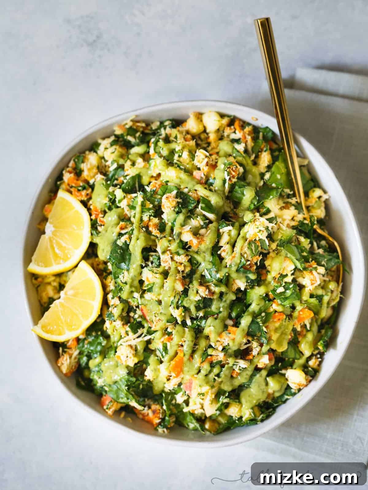Discover the Fresh Ingredients of this Easy Harvest Chopped Salad Recipe A close-up shot of the Harvest Chopped Salad ingredients, showcasing the tender kale, roasted sweet potato cubes, and crisp apple pieces.