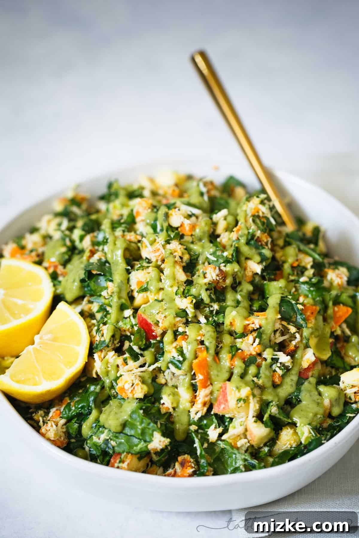 The Secret to an Amazing Chopped Salad: Homemade or Store-Bought Green Goddess Dressing A vibrant Harvest Chopped Salad Bowl with Green Goddess dressing drizzled generously over the top, ready to be tossed and enjoyed.