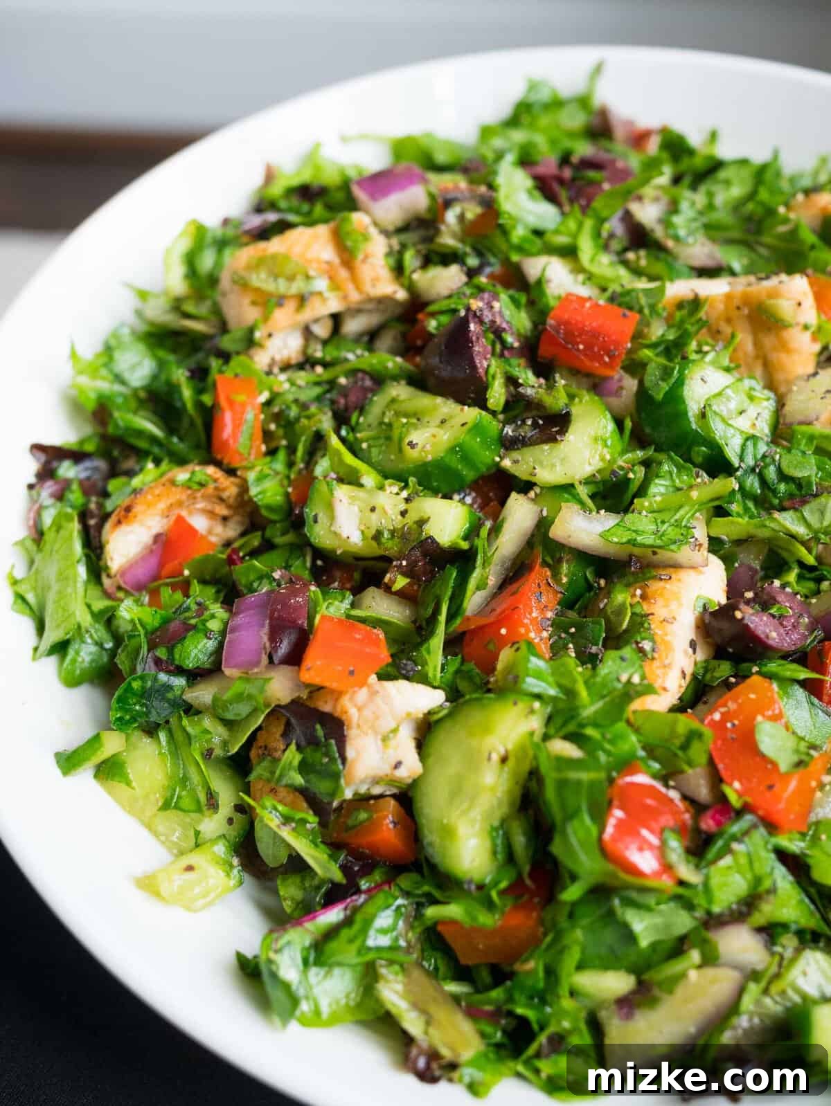 Fresh Chopped Salad: A Healthy and Convenient Meal Option A close-up view of the perfectly chopped salad, showcasing its fresh ingredients and inviting textures, ready to be dressed and enjoyed as a quick, healthy, and easy meal.