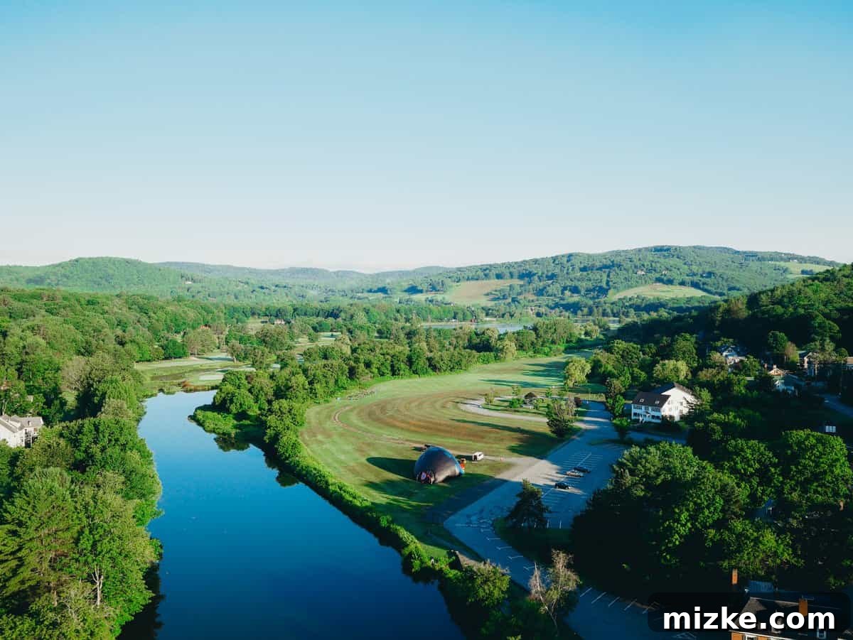 Your Ultimate Guide to Woodstock Vermont 20 Hot air balloon majestically ascending over the green landscape of Vermont