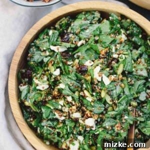 The finished nutty spinach and quinoa salad, presented beautifully in a bowl, ready to be served.