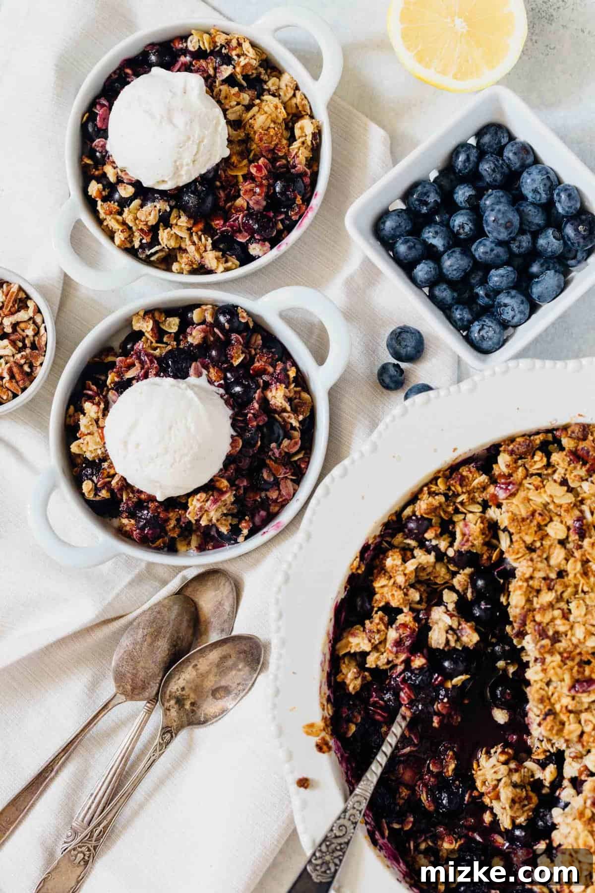 Effortless Blueberry Pecan Crumble: The Ultimate Dessert for Dinner Parties and Gatherings A slice of warm blueberry pecan crumble served with a scoop of vanilla ice cream.