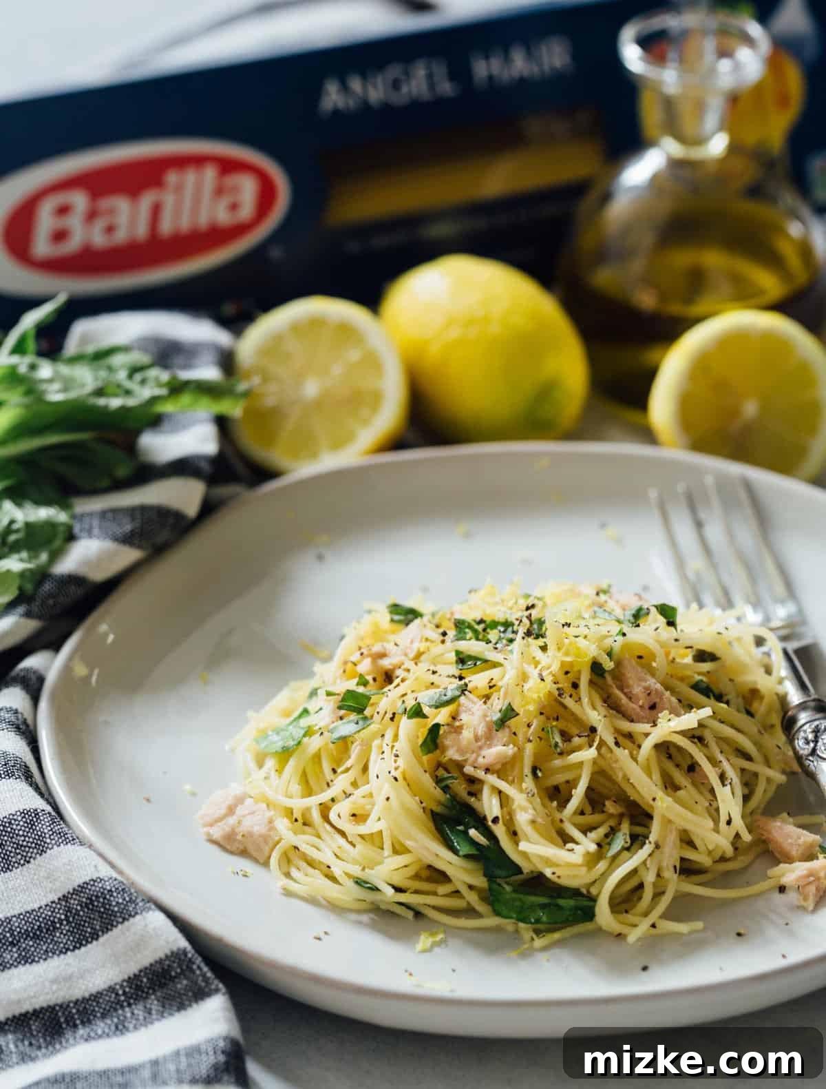 Sunshine Tuna Pasta 6 A perfectly portioned serving of zesty tuna pasta, presented in a bowl and ready to be enjoyed immediately.