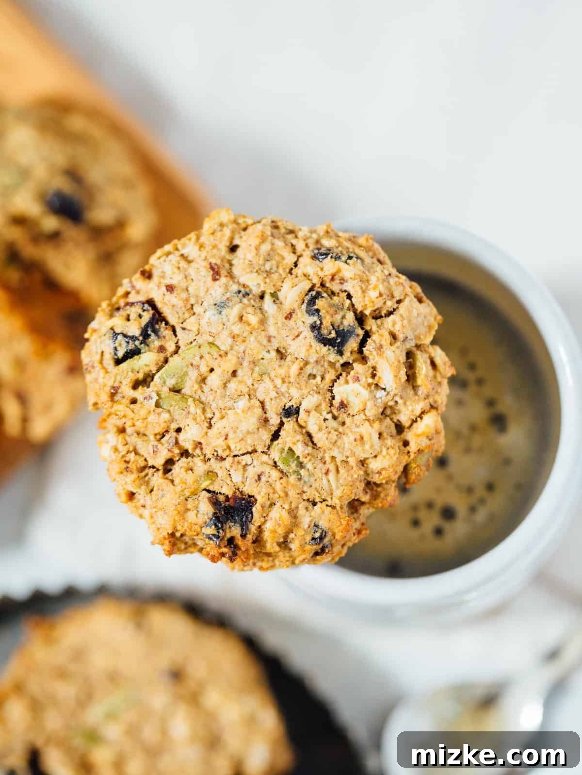 Healthy On-the-Go Breakfast Cookies A batch of baked naturally sweetened vegan and gluten-free breakfast cookies cooling on a wire rack, perfect for meal prep.