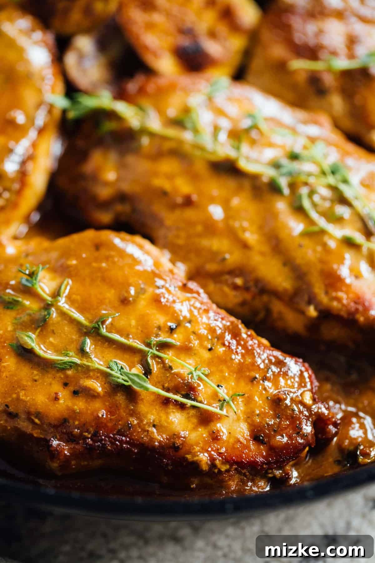 Seared Boneless Pork Chops in Skillet Perfectly seared boneless pork chops ready to be coated in the sweet and tangy apricot balsamic glaze, promising a delicious dinner. #bonelessporkchops #porkchoprecipes #skilletcooking #dinnerideas