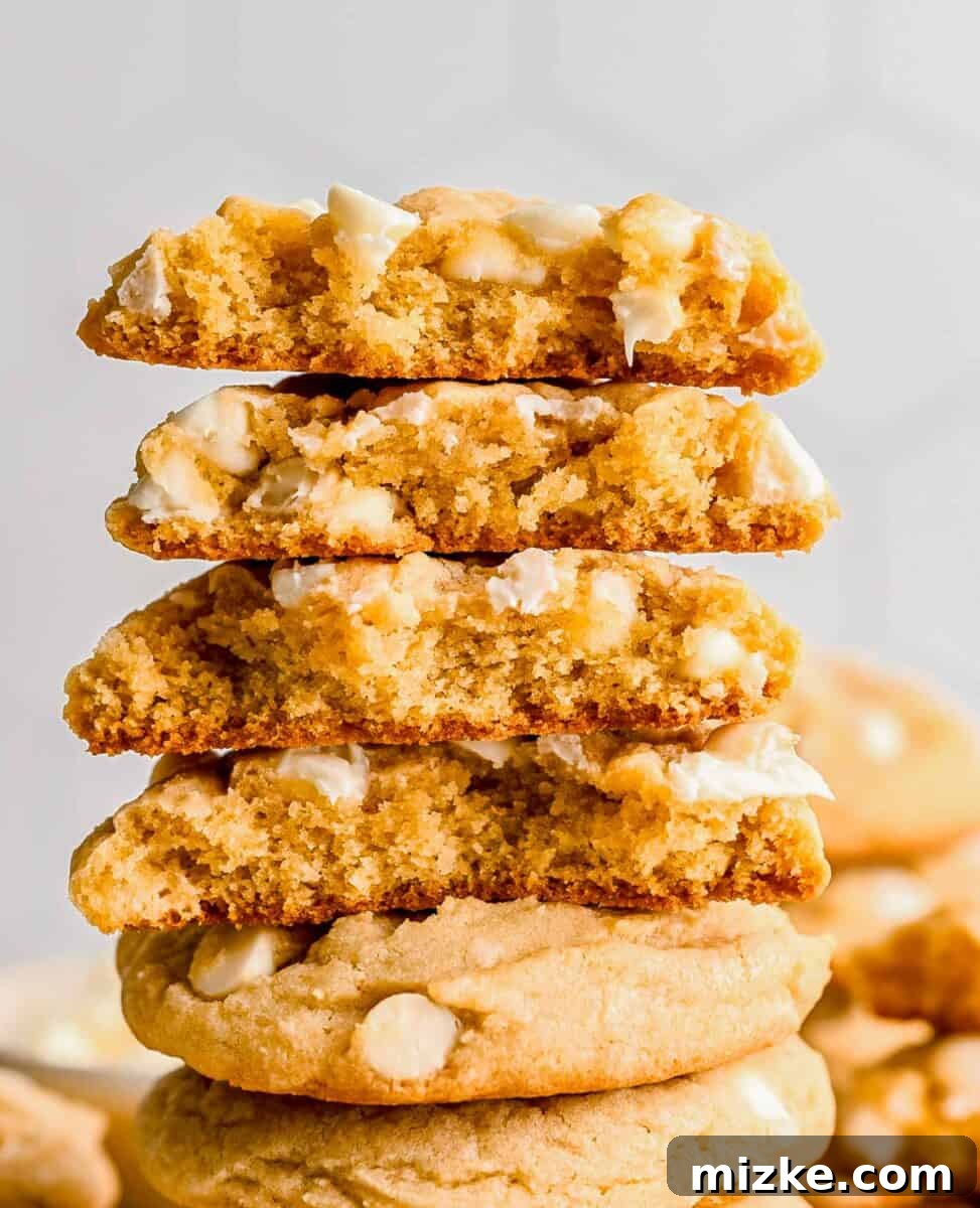 Heavenly White Chocolate Chip Cookies 5 Halved white chocolate chip cookies stacked to reveal their soft, chewy centers.