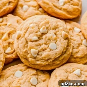 A delicious white chocolate chip cookie with prominent white chocolate pieces.