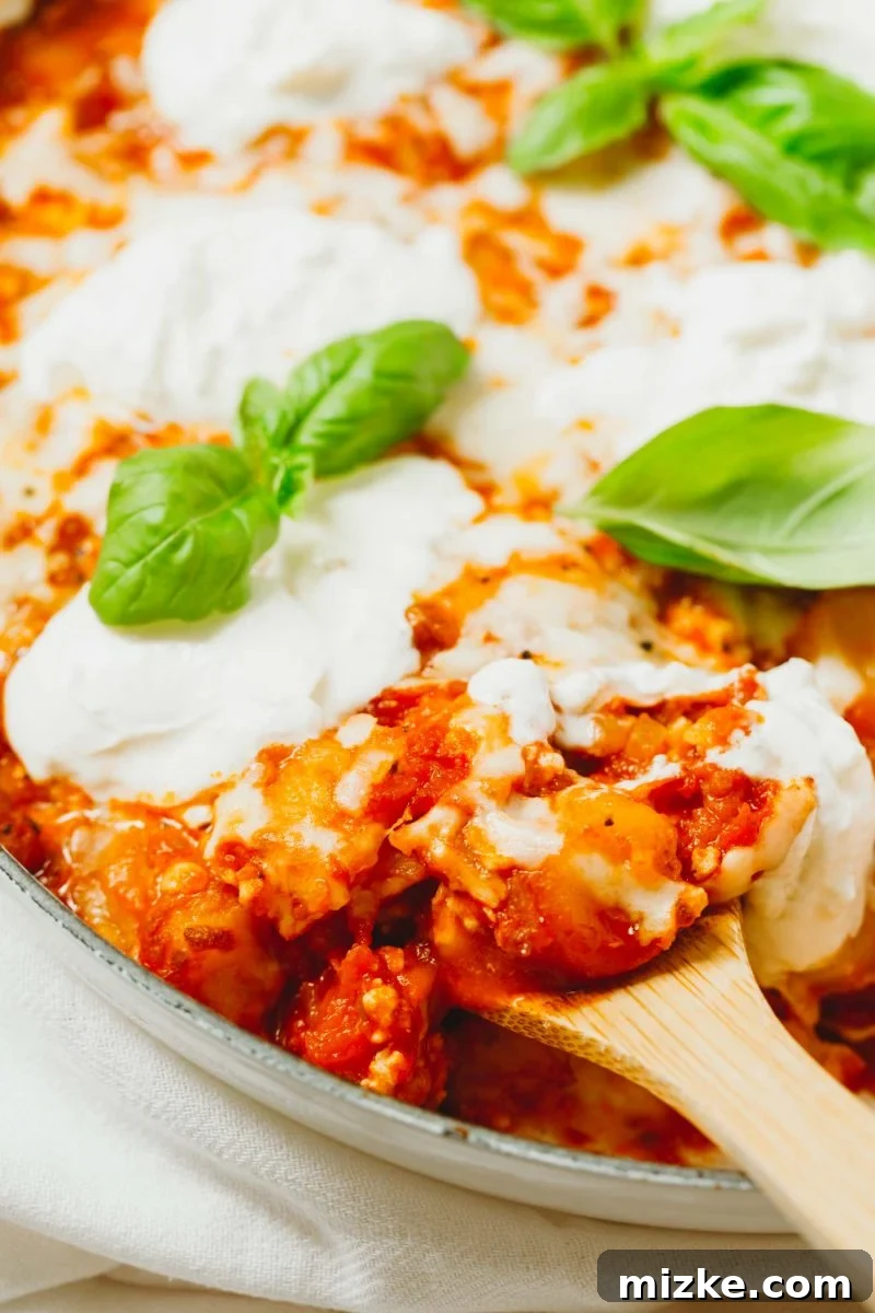 An easy dinner idea is this low-carb chicken parmesan gnocchi bake that is put together in one skillet! A great way to use that cauliflower gnocchi if you need ideas on how to use it! A savory low-carb chicken parmesan gnocchi bake, ideal for a quick and satisfying dinner using cauliflower gnocchi.