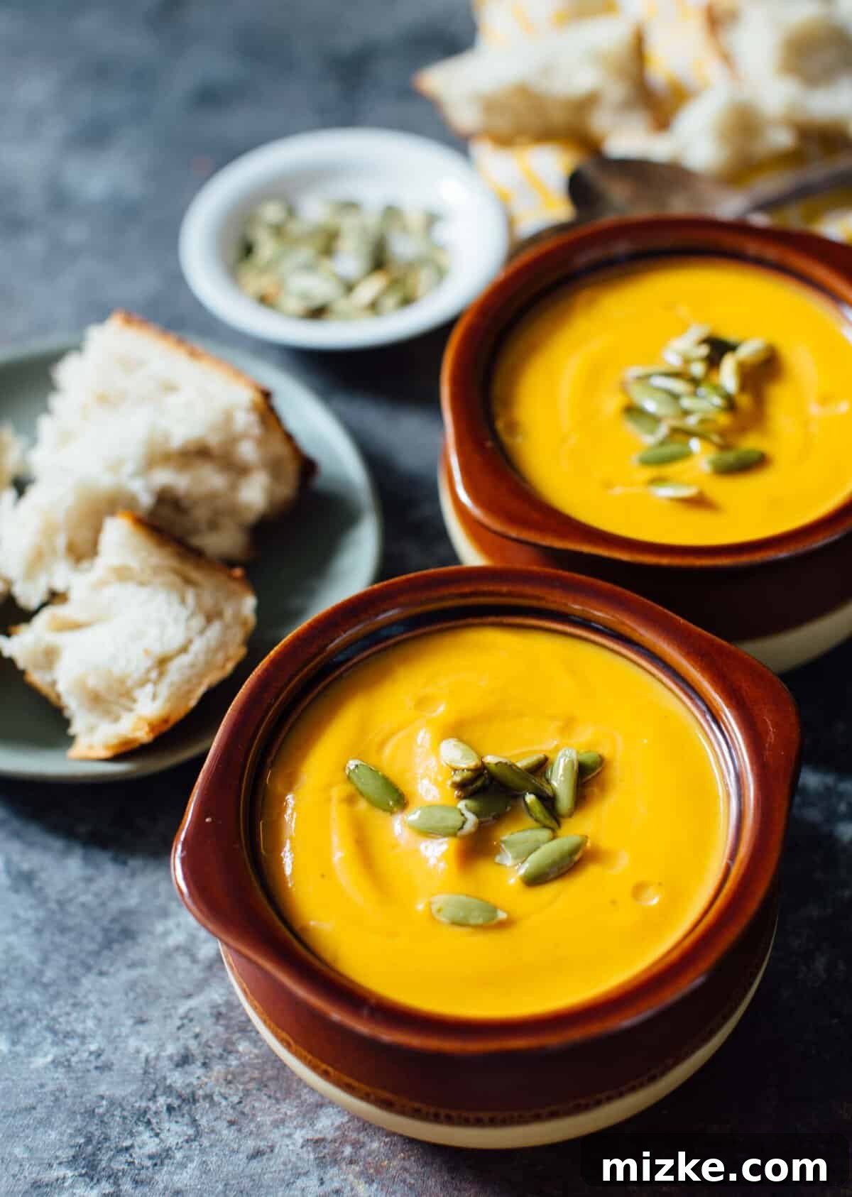Served Butternut Squash Soup A bowl of creamy Instant Pot Autumn Harvest Butternut Squash Soup, garnished and ready to serve, embodying homemade comfort.