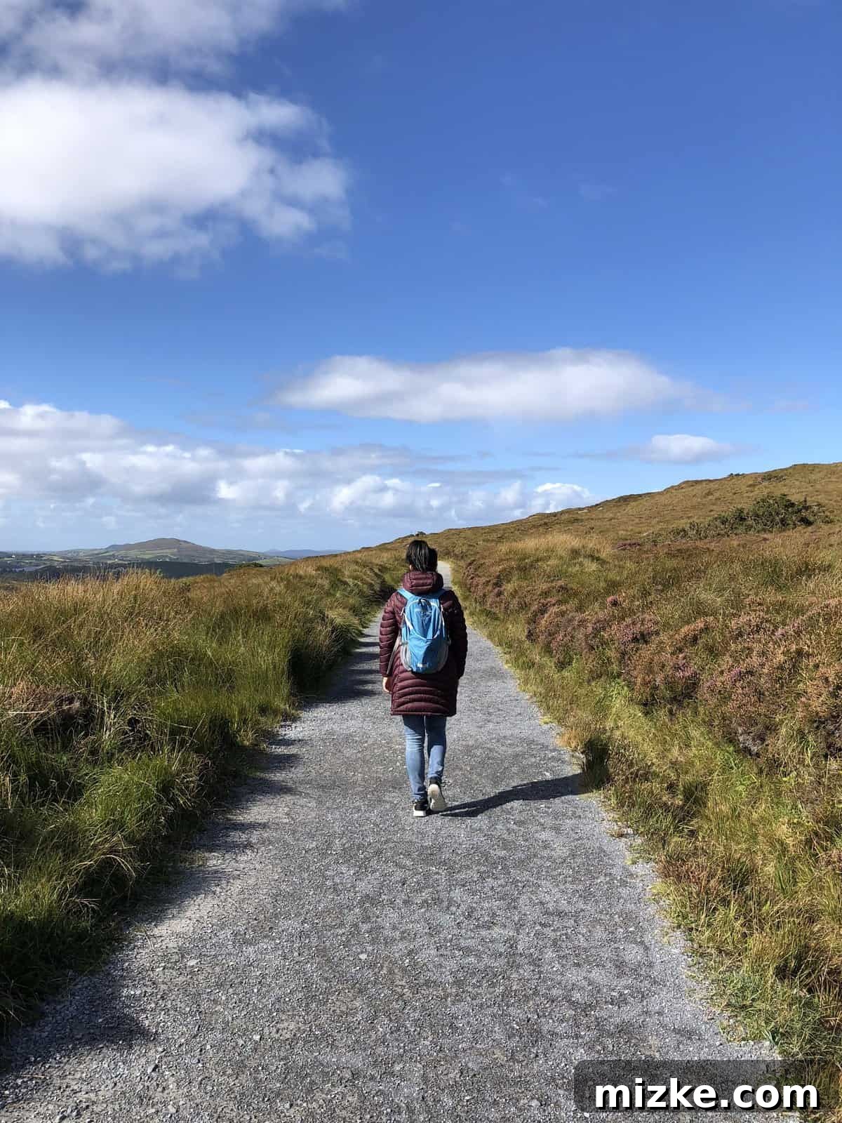 Trekking and Views on Diamond Hill Hiker enjoying the expansive, wild landscape from the heights of Diamond Hill, Connemara