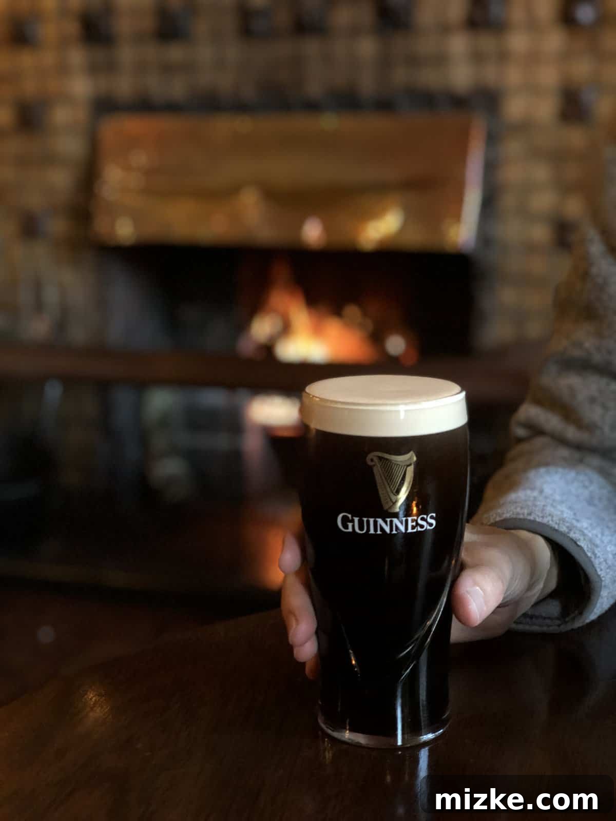 Enjoying a Guinness in an Irish Pub A perfectly poured pint of Guinness, a classic Irish experience at a pub