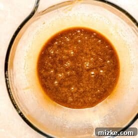 Brown butter mixture in a glass mixing bowl