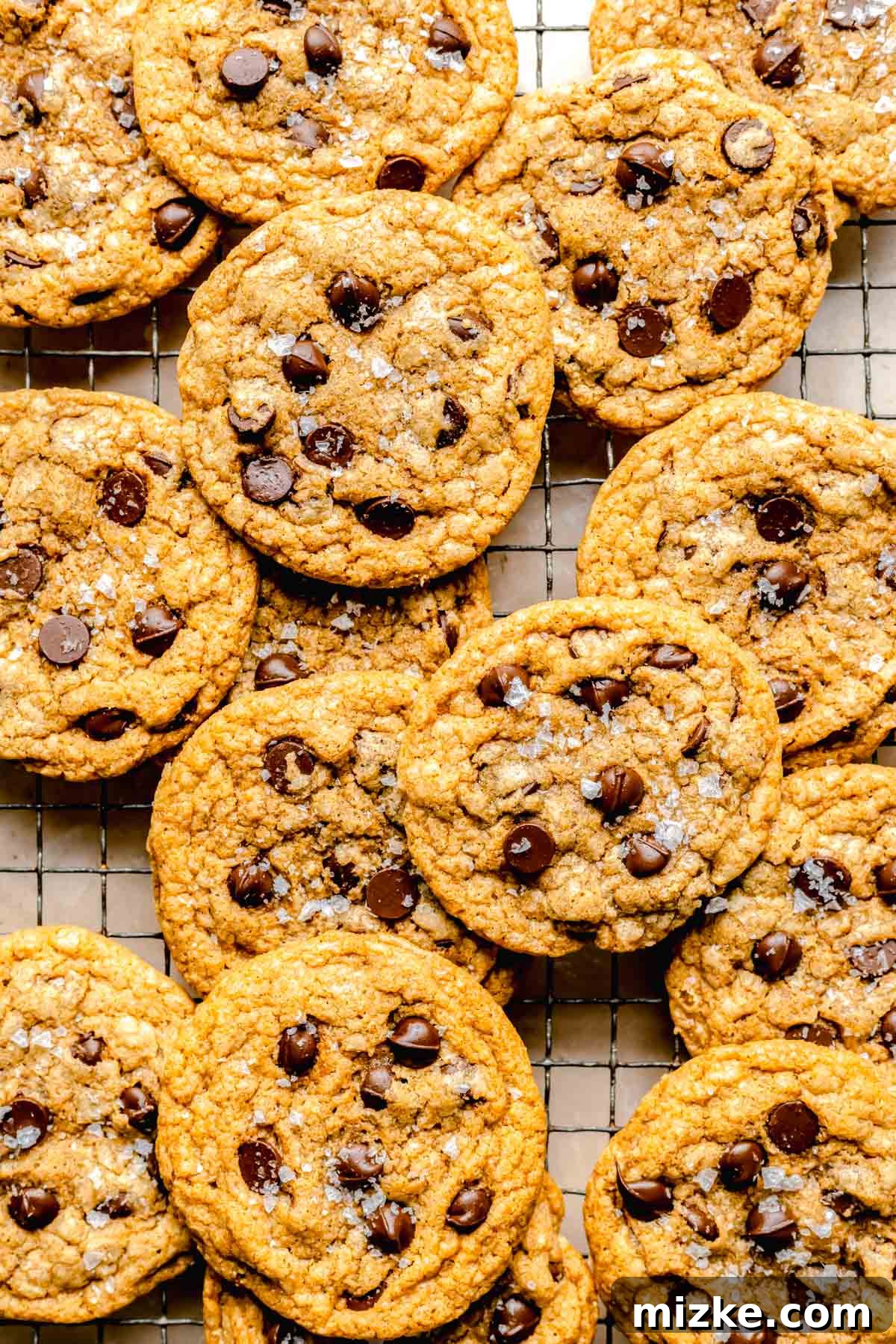 Caramelized Butter Chocolate Chip Cookies 9 Freshly baked brown butter chocolate chip cookies cooling on a wire rack, allowing them to set and achieve their perfect texture.