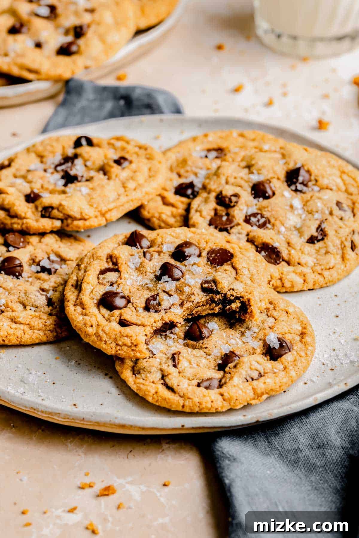Caramelized Butter Chocolate Chip Cookies 10 Several perfectly round brown butter chocolate chip cookies artfully arranged on a simple round plate, ready to be enjoyed.