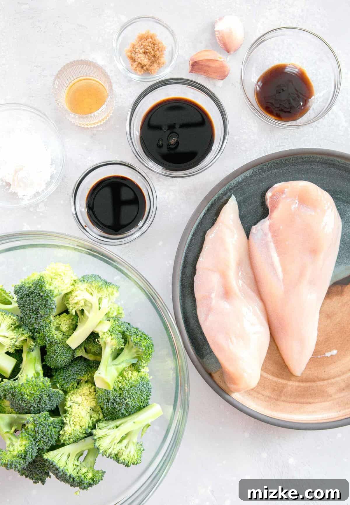 Gather your ingredients for homemade Chinese Chicken and Broccoli: chicken, broccoli, and a savory sauce base for an authentic taste! Overhead flat lay of all ingredients for homemade Chinese Chicken and Broccoli, including fresh broccoli florets, various soy sauces, cornstarch, sesame oil, brown sugar, minced garlic, oyster sauce, and boneless skinless chicken breasts.
