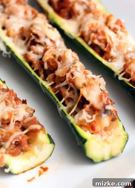 Stuffed Zucchini 3 A second close-up view of the prepared zucchini boats, showcasing the rich filling and golden-brown melted cheese topping.