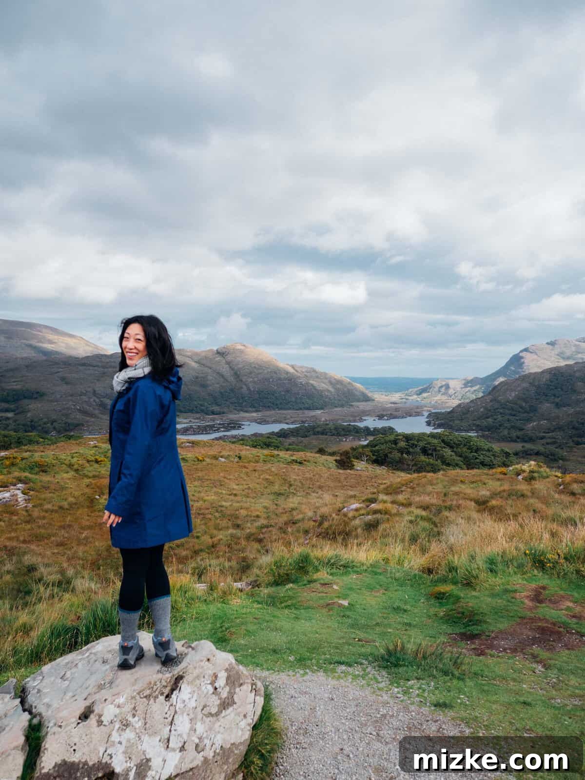 Killarney: Ireland's Emerald Gem 10 Dramatic dark skies over a vast, serene lake surrounded by rolling hills and dense forests