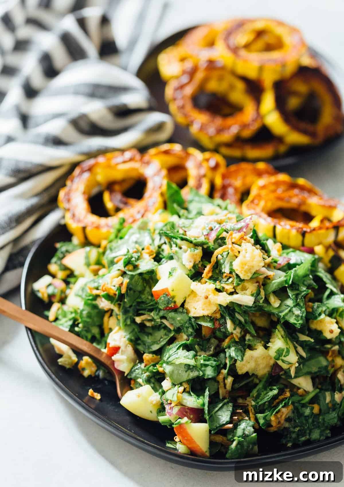A spinach tuna salad topped with roasted delicata squash is a heavenly combination! The delicata squash gives it a unique yet distinct sweetness but it also adds volume to make this salad hearty and filling! The finished spinach tuna salad with roasted delicata squash, beautifully presented and ready to be enjoyed. The rich textures and vibrant colors promise a delightful and filling meal. The delicata squash brings its signature sweetness and provides a substantial base, making every spoonful a hearty and satisfying experience.