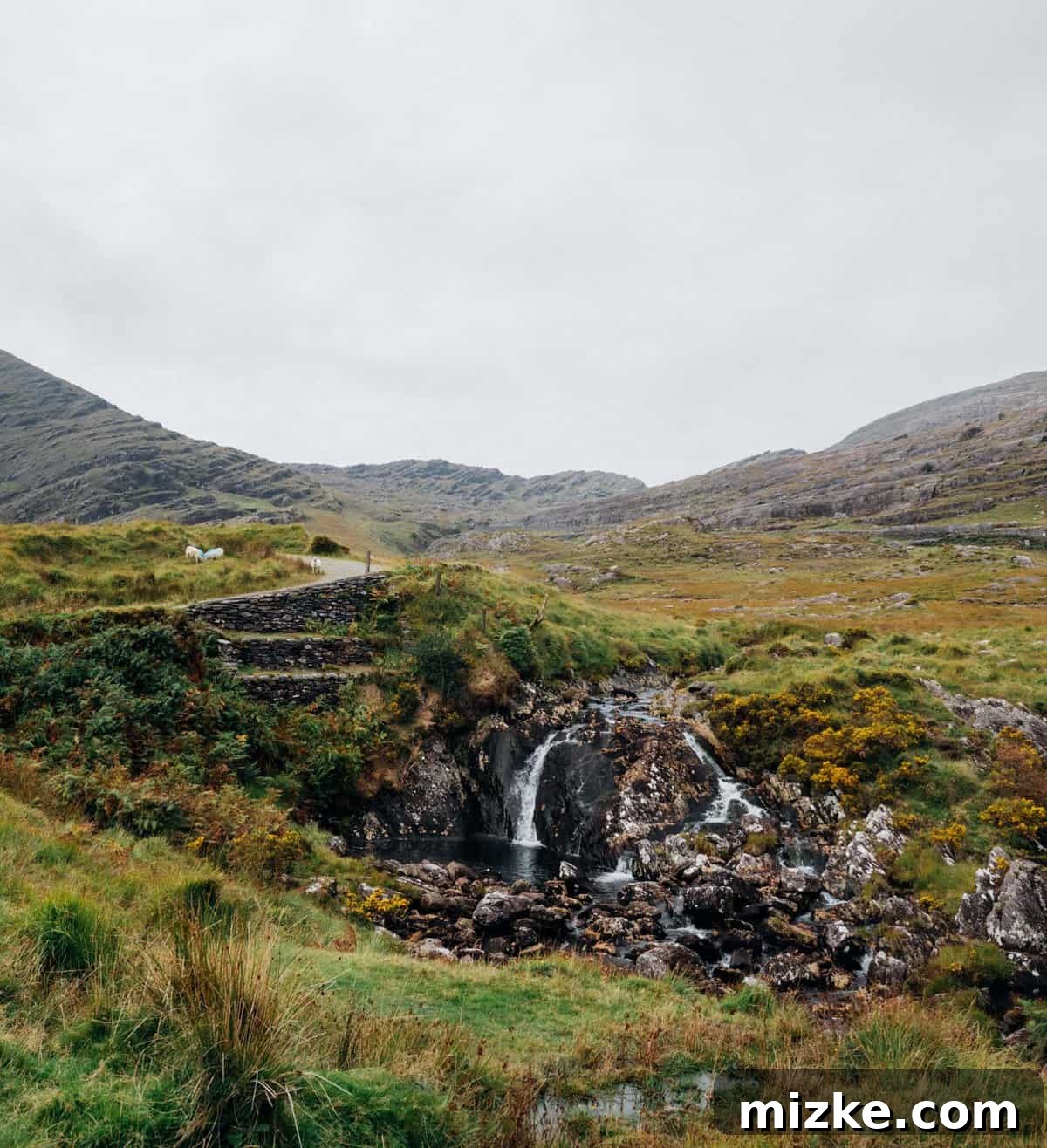 Ireland's Rugged Beara Peninsula 20 Winding mountain road of Healy Pass ascending through rugged terrain under a bright sky