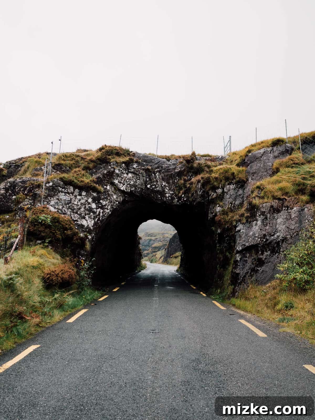 Ireland's Rugged Beara Peninsula 3 Rugged, almost barren landscape with winding road and distant hills, reminiscent of Iceland