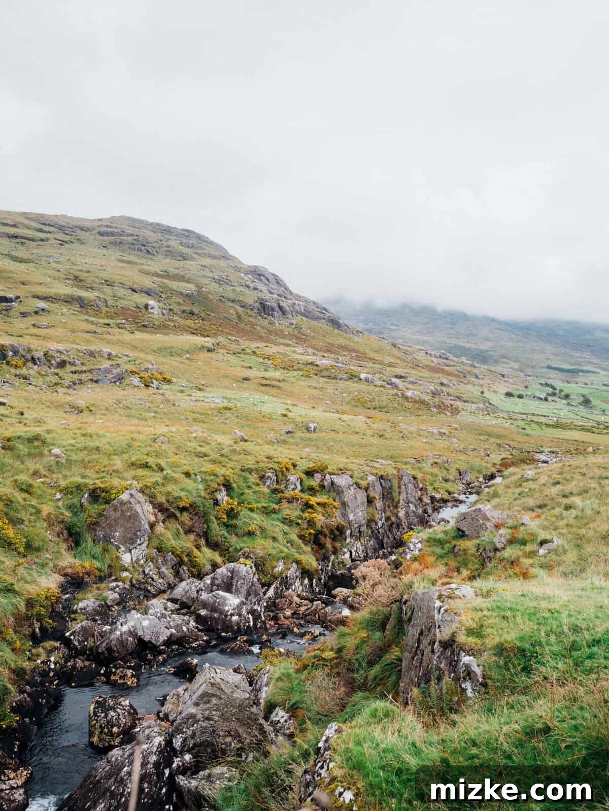 Ireland's Rugged Beara Peninsula 21 Dramatic view looking down Healy Pass with a road snaking through a green valley