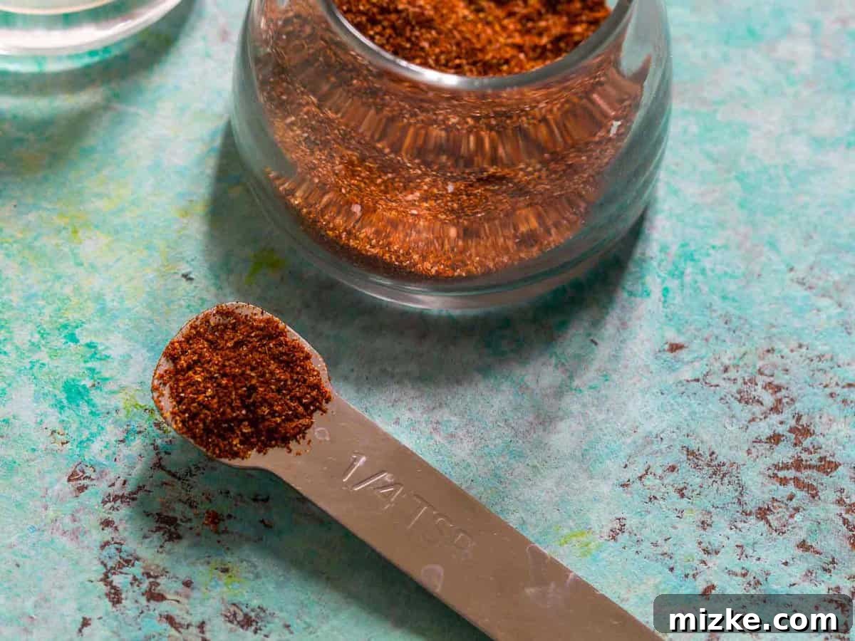 No need for store-bought fajita seasoning packets when you can easily create a healthier, customized blend at home. You'll know every ingredient that goes in and can adjust it perfectly to your taste! Measuring spoon and glass jar filled with homemade fajita seasoning
