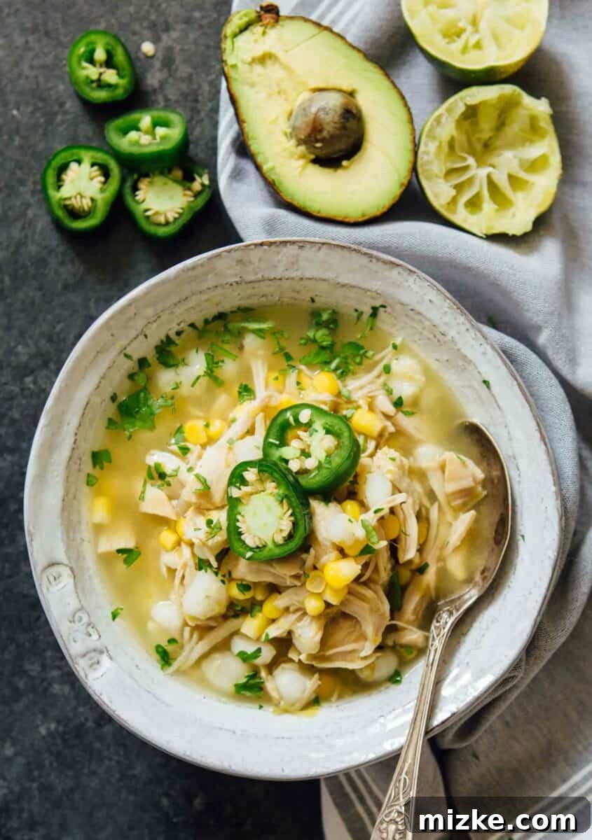This Instant Pot jalapeño lime chicken soup is beyond flavorful! The spicy broth has hearty additions of hominy, corn, and shredded chicken. Put this all together in less than an hour! Flavorful Instant Pot Jalapeño Lime Chicken Soup with hominy, corn, and shredded chicken, prepared in under an hour.