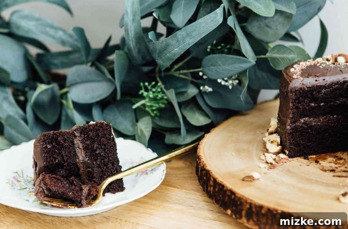 Elegant Mini Chocolate Malt Cake: A Dessert for Every Occasion This mini chocolate malt cake for two is perfect for any celebration or if you're just craving a chocolate cake and don't want to make a large one! Close-up of mini cake on a serving plate.