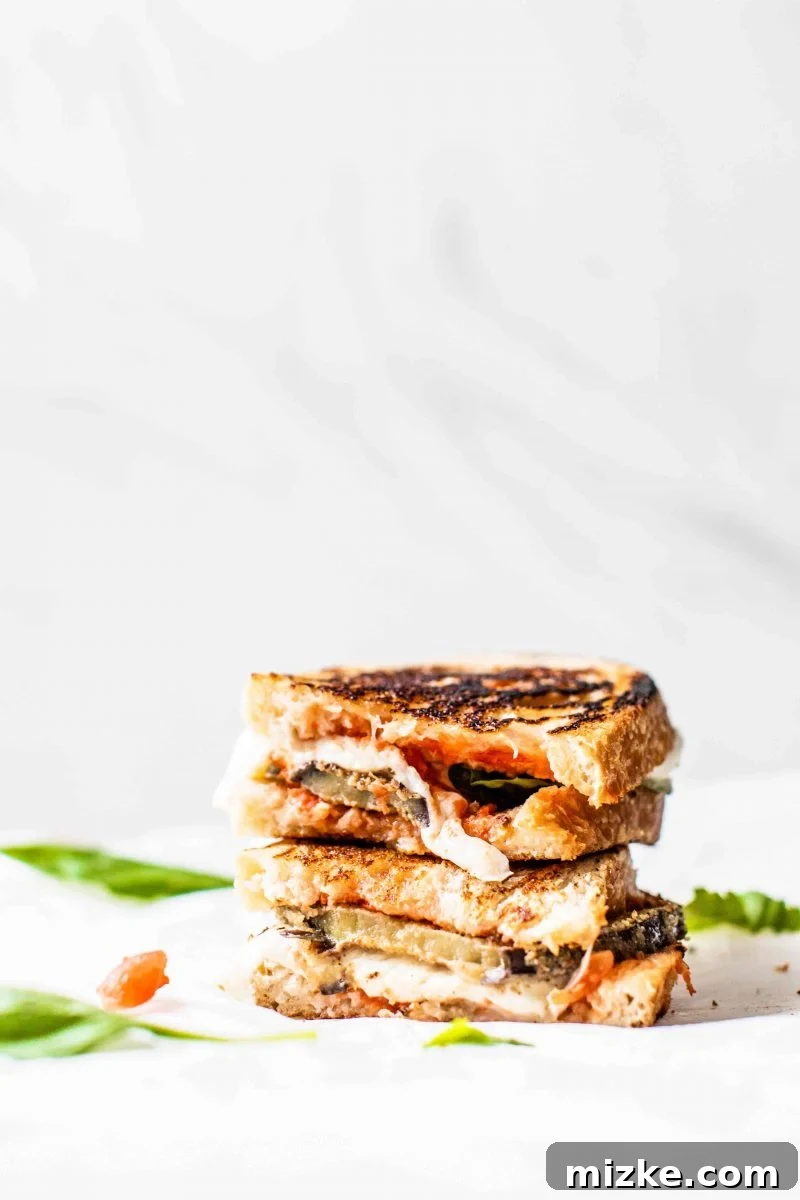 Pressed Eggplant Parmesan Sandwich A perfectly pressed and grilled Eggplant Parmesan Sandwich, golden brown and ready to eat.