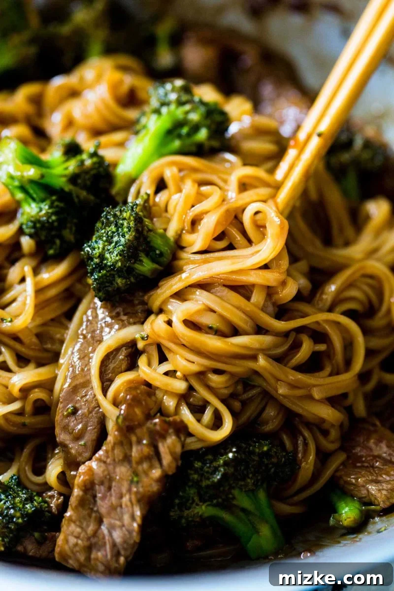 A serving of Asian Beef and Broccoli Noodles presented in a bowl, ready to be enjoyed. The inviting aroma and vibrant colors make it a must-try dish for any home cook.