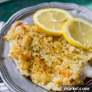 Crispy baked haddock on a plate, garnished with lemon slices, a delicious and quick seafood dinner