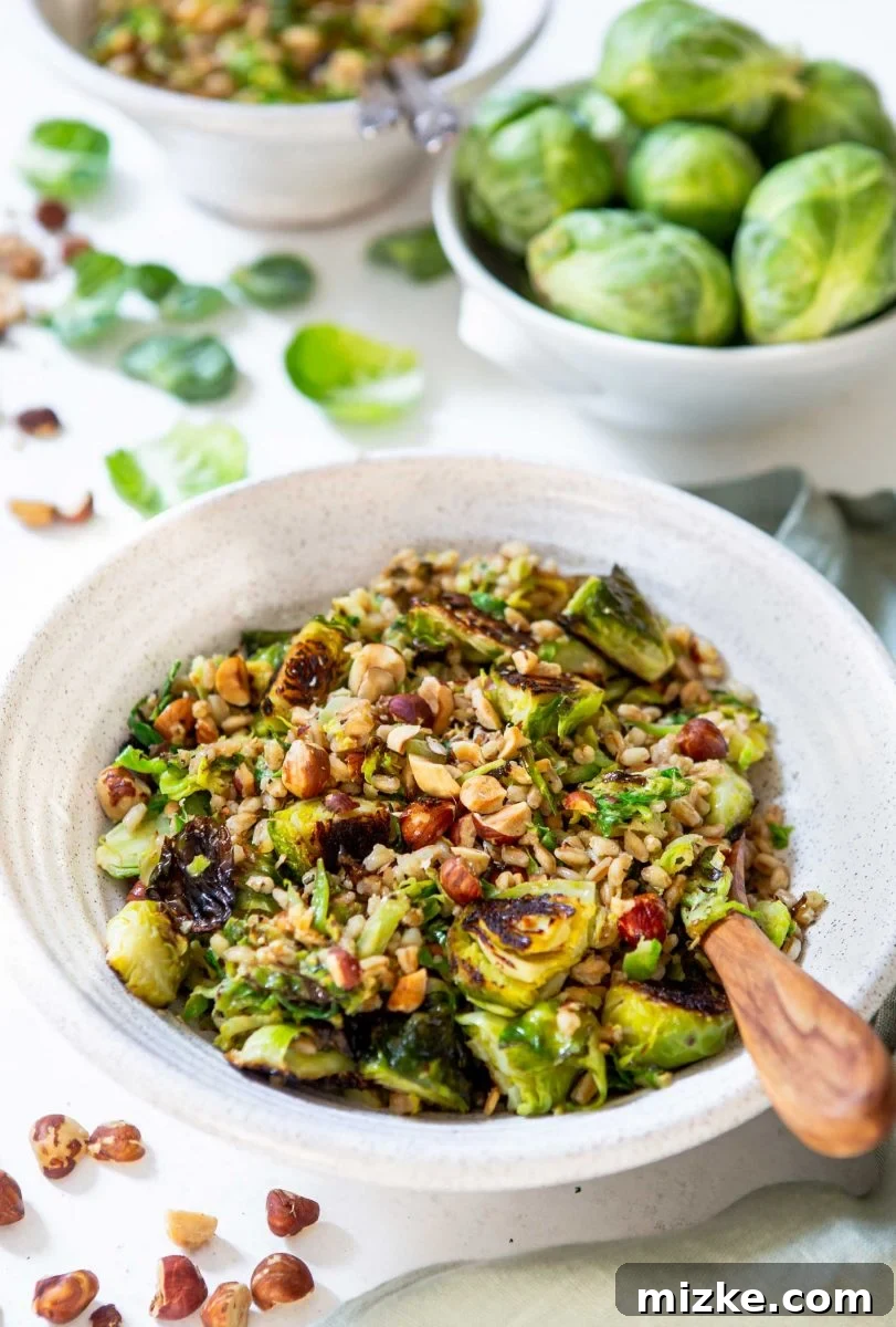 A serving of the warm roasted Brussels sprouts and farro salad, showcasing the vibrant green of the sprouts, the earthy tone of the farro, and the golden crunch of hazelnuts, dressed to perfection.