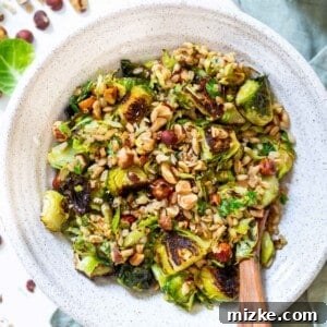 The perfect springtime salad! This warm roasted brussels sprouts salad with farro is tossed in a delicious Dijon shallot dressing that is flavorful and a delight! The hazelnuts give this salad that extra crunch and texture!