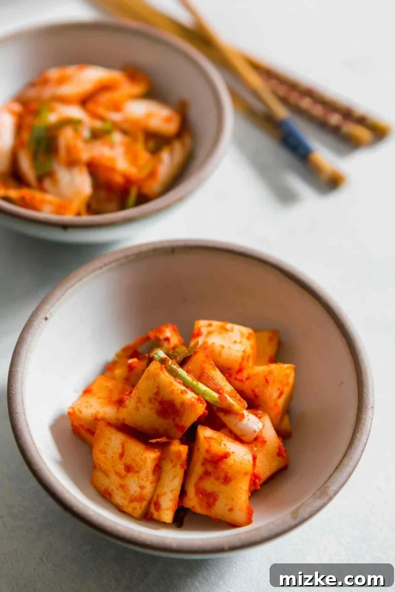 Witnessing the active fermentation of homemade kimchi in preparation for storage. A close-up of clear glass mason jars filled with freshly packed, vibrant homemade kimchi, showcasing the fermentation process