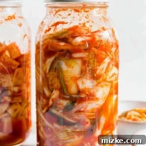 A beautifully arranged bowl of freshly prepared, vibrant homemade kimchi, showcasing its rich red color and inviting texture.