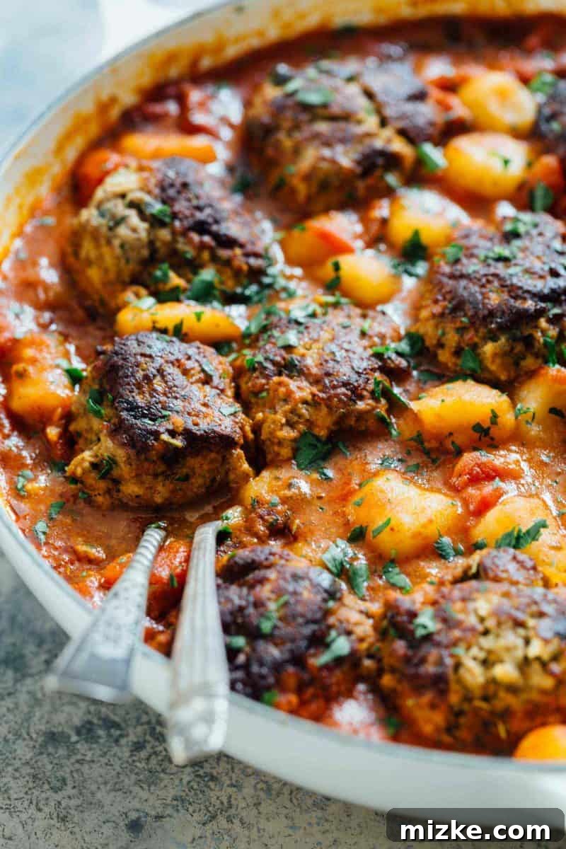 Perfectly browned meatballs simmering in a vibrant red marinara sauce, ready to be combined with gnocchi. Perfectly browned meatballs simmering in a vibrant red marinara sauce, ready to be combined with gnocchi.