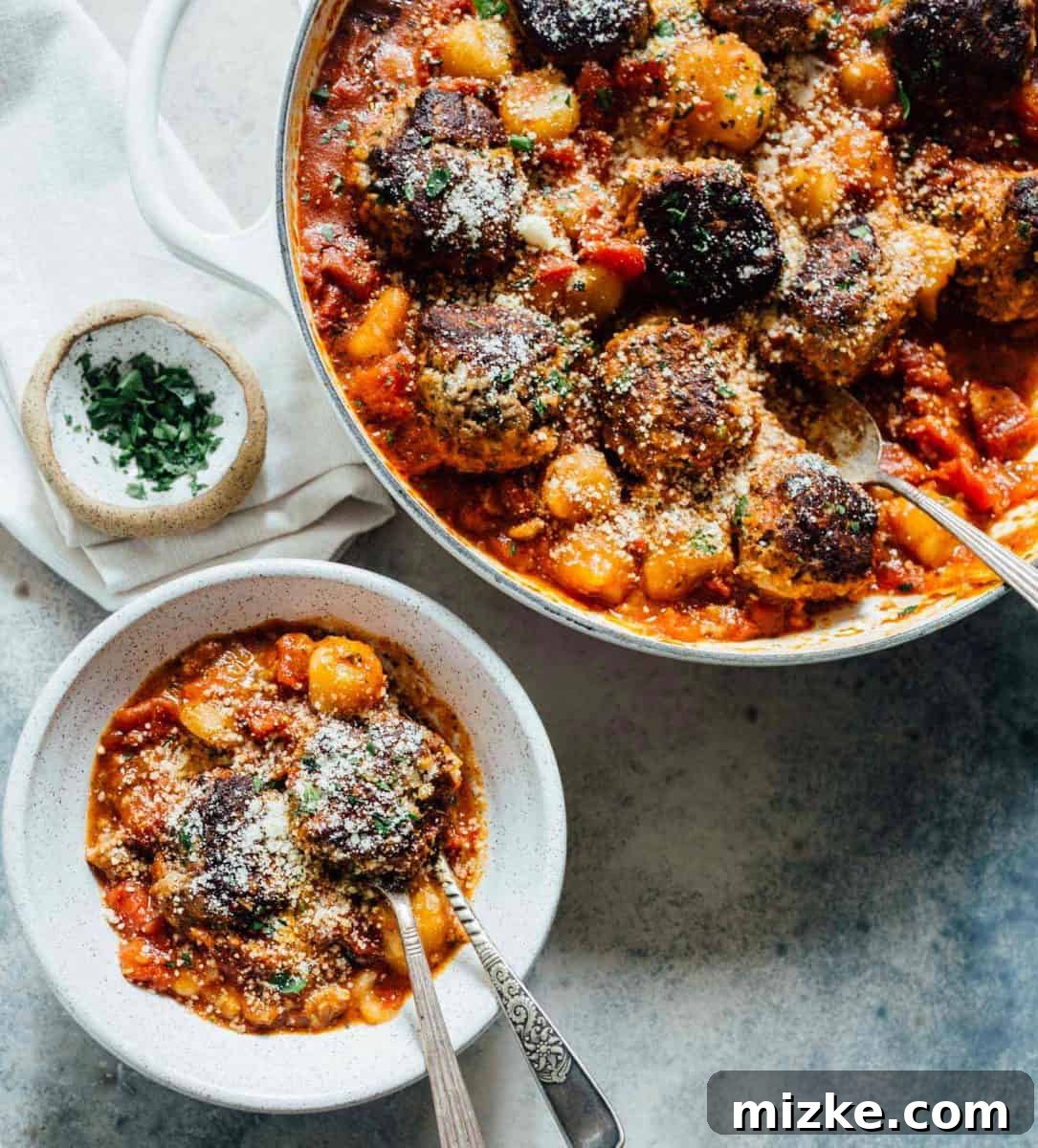 A close-up shot of the tender cauliflower gnocchi and meatballs, showcasing their appealing texture and rich sauce. A close-up shot of the tender cauliflower gnocchi and meatballs, showcasing their appealing texture and rich sauce.