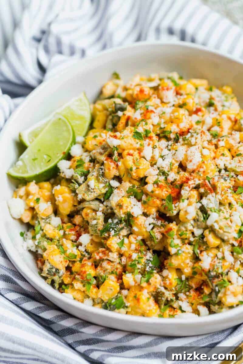 Poblano Elote Bowl 2 A vibrant bowl of creamy and smoky Poblano Mexican Street Corn off the cob, garnished with fresh parsley and a lime wedge. Perfect for a summer BBQ or a quick, flavorful side dish.