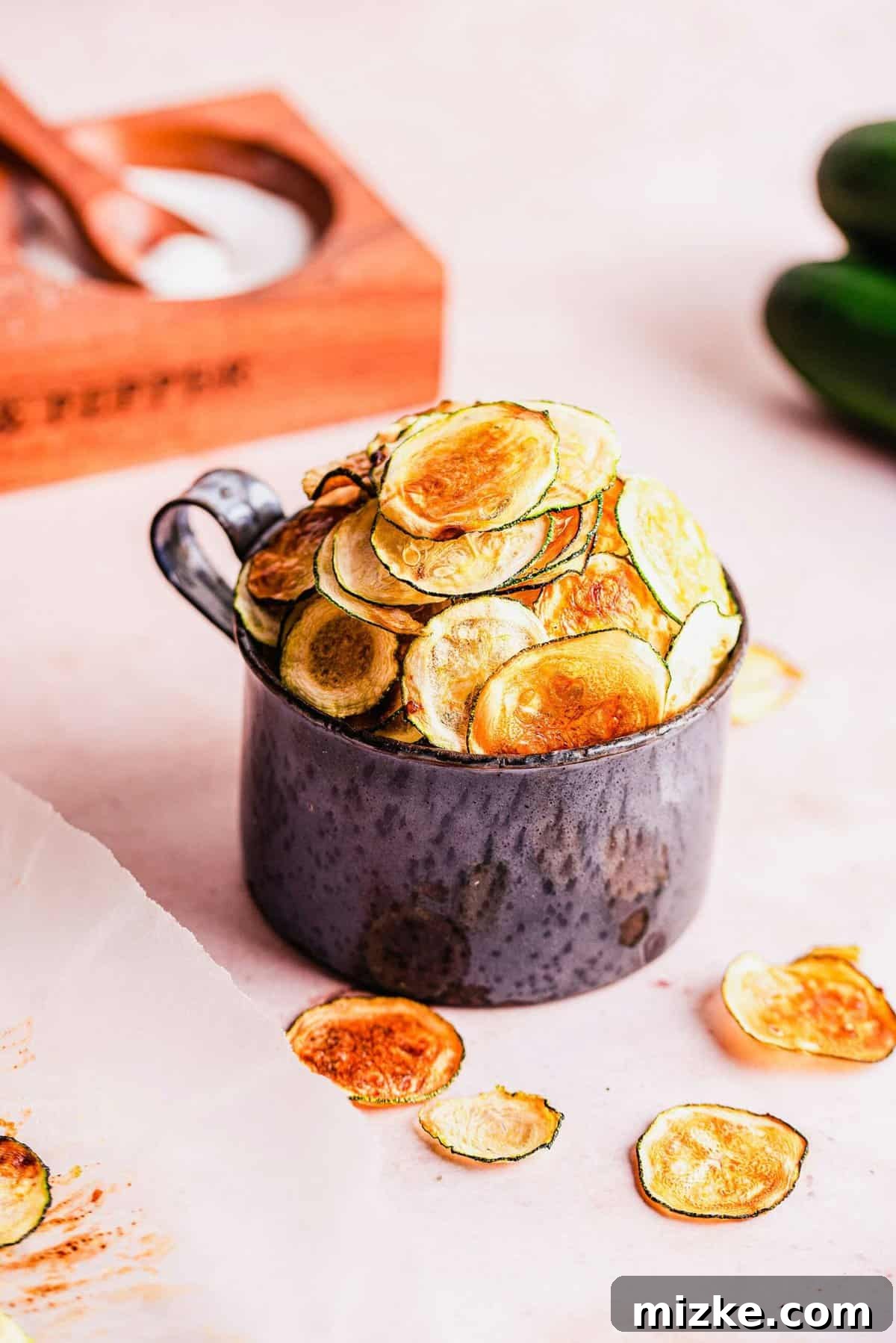 Simple Golden Zucchini Crisps 3 Small crock filled with golden, crispy zucchini chips