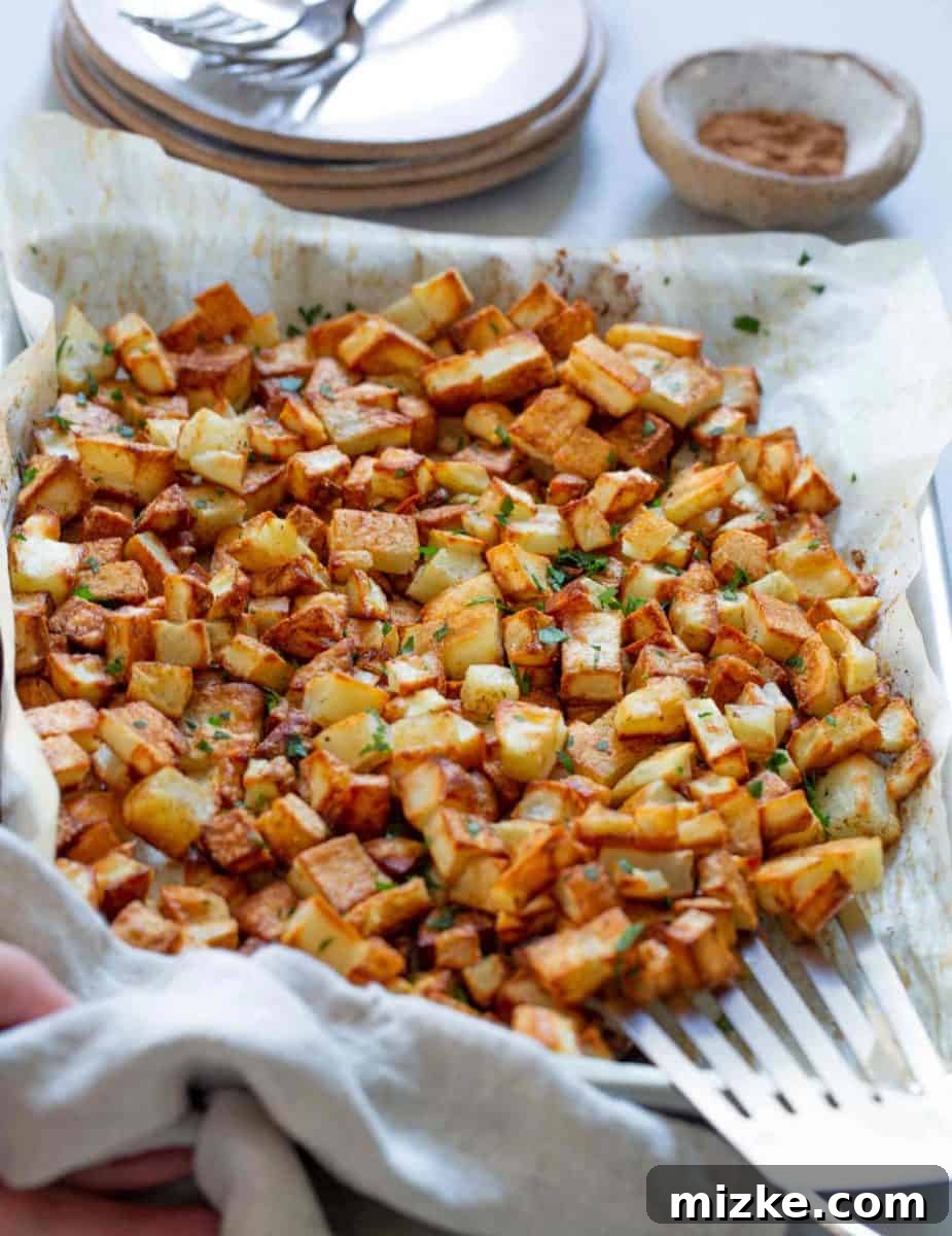 Golden Roasted Five Spice Potatoes 2 Golden brown roasted five spice potatoes in a rustic bowl, showcasing their crispy texture and aromatic spices.