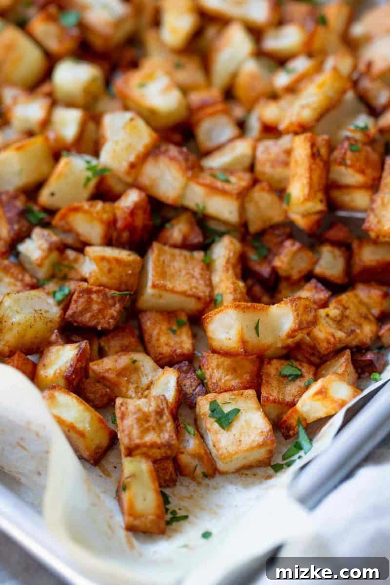 Golden Roasted Five Spice Potatoes 5 A baking sheet filled with cubed potatoes tossed in five-spice powder and oil, ready for the oven.